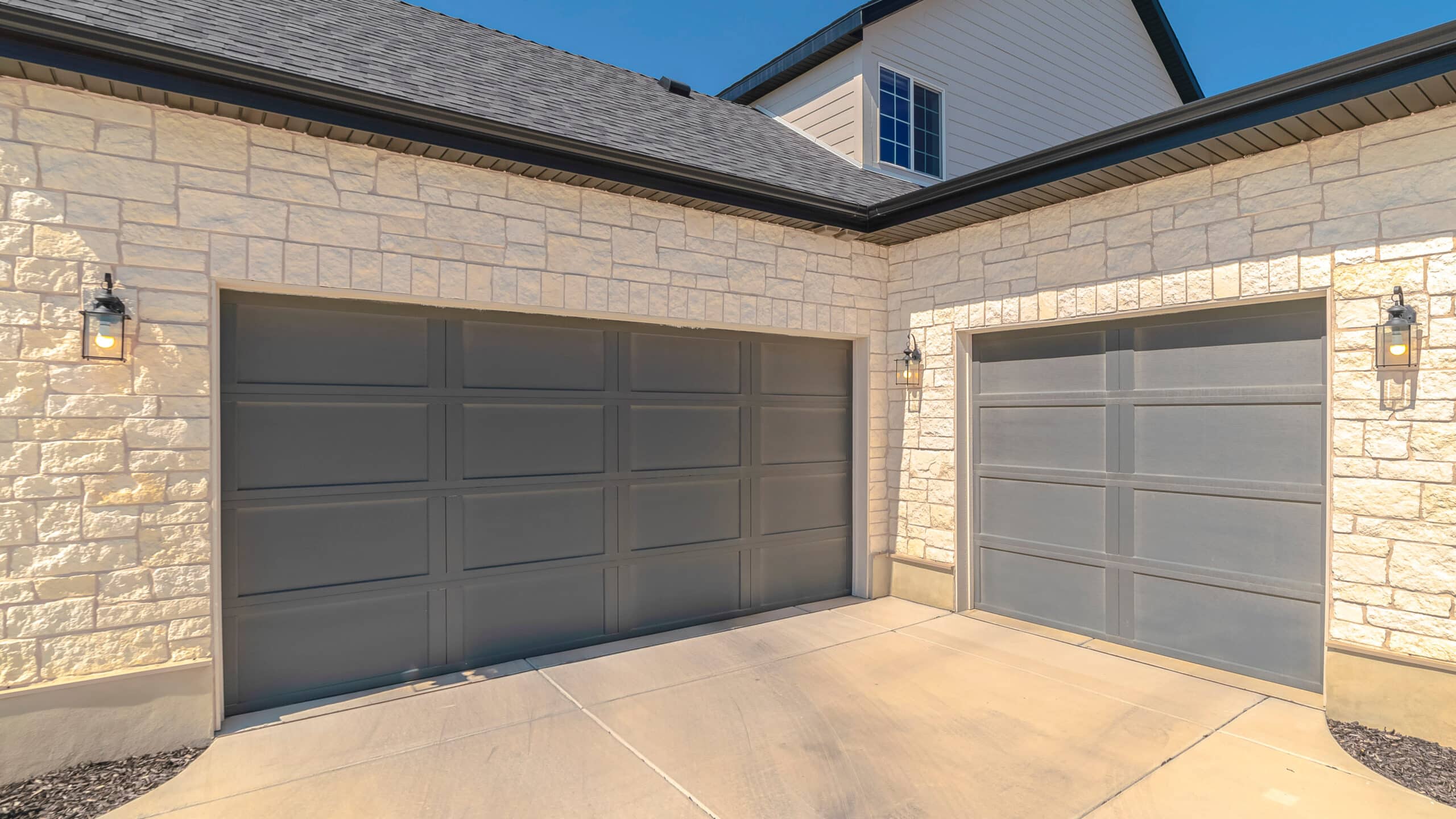 Panorama frame Three car garage and driveway of suburban home