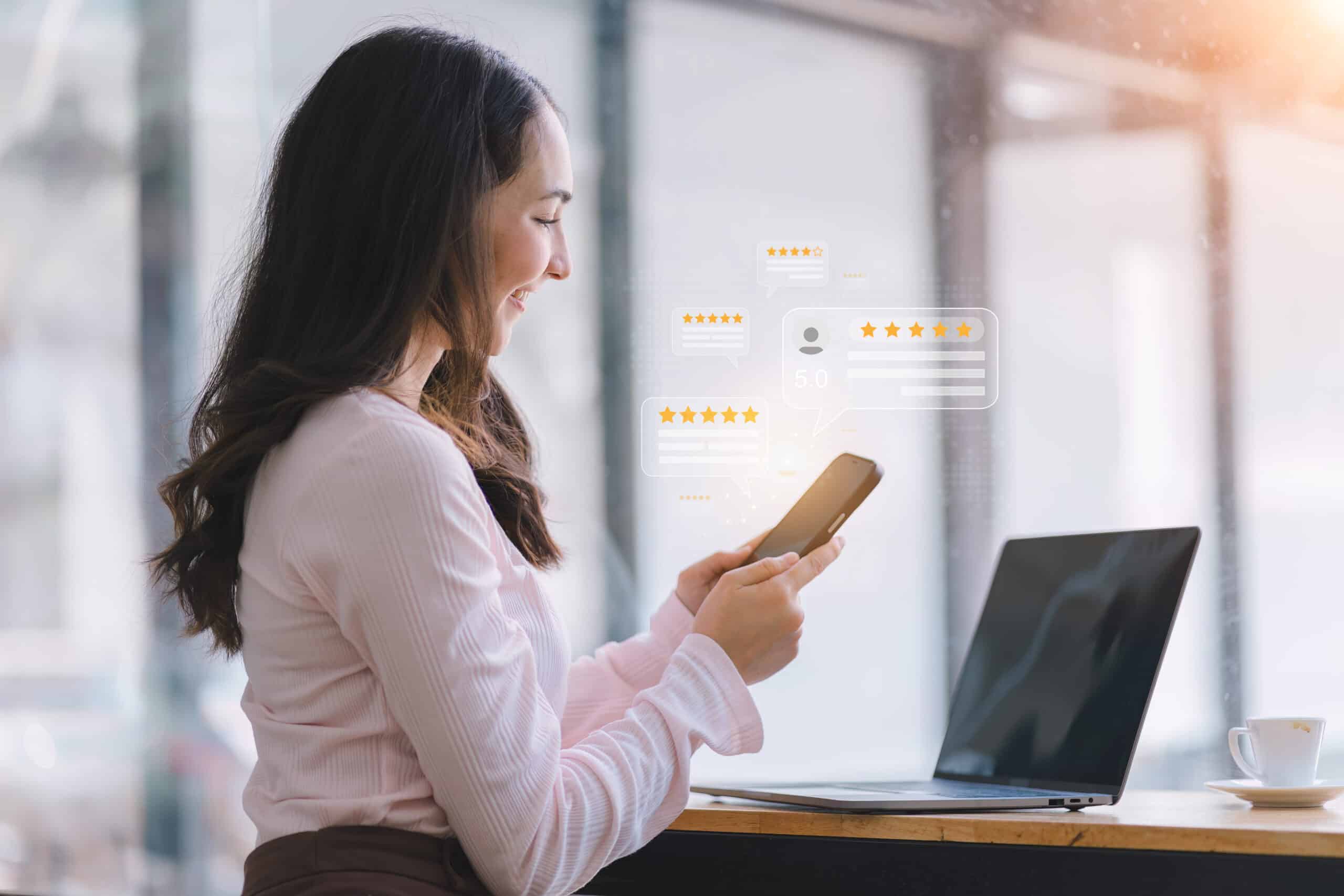 A customer hands pressing on a smartphone screen with a gold five star rating feedback icon.User give rating to service experience on online application. Client review and customer rating concept